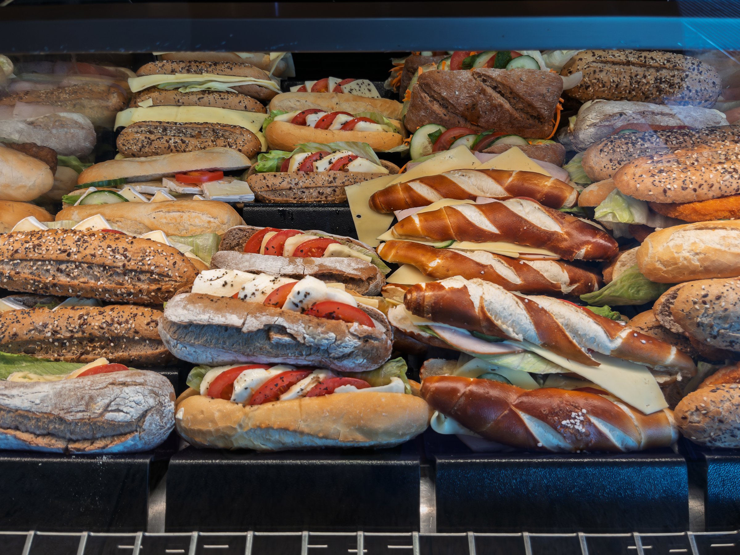 Assorted Gourmet Sandwiches Displayed in Deli Case