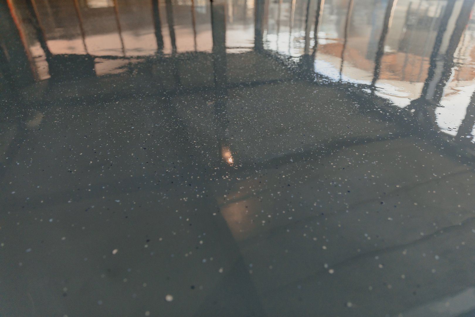 Smooth, glossy floor with reflective resin coating in industrial setting