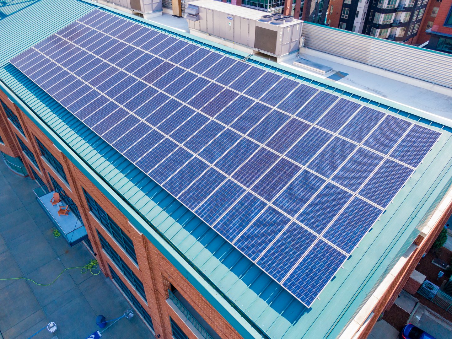Commercial building rooftop with solar panels bright sunny day