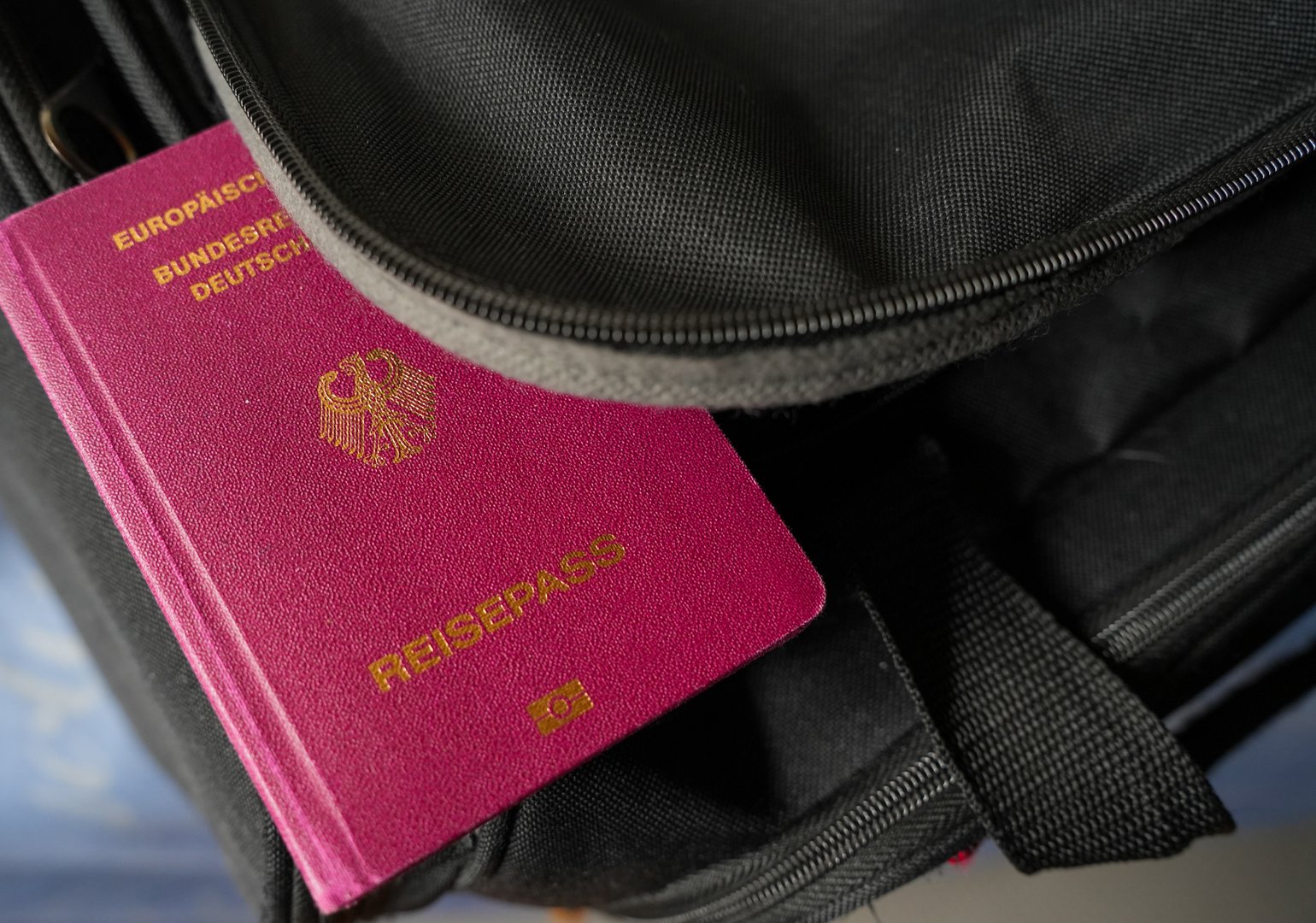 Germany. July 11, 2025. German passport on a  travel bag symbolizing freedom, mobility, and readiness for international adventures and new destinations