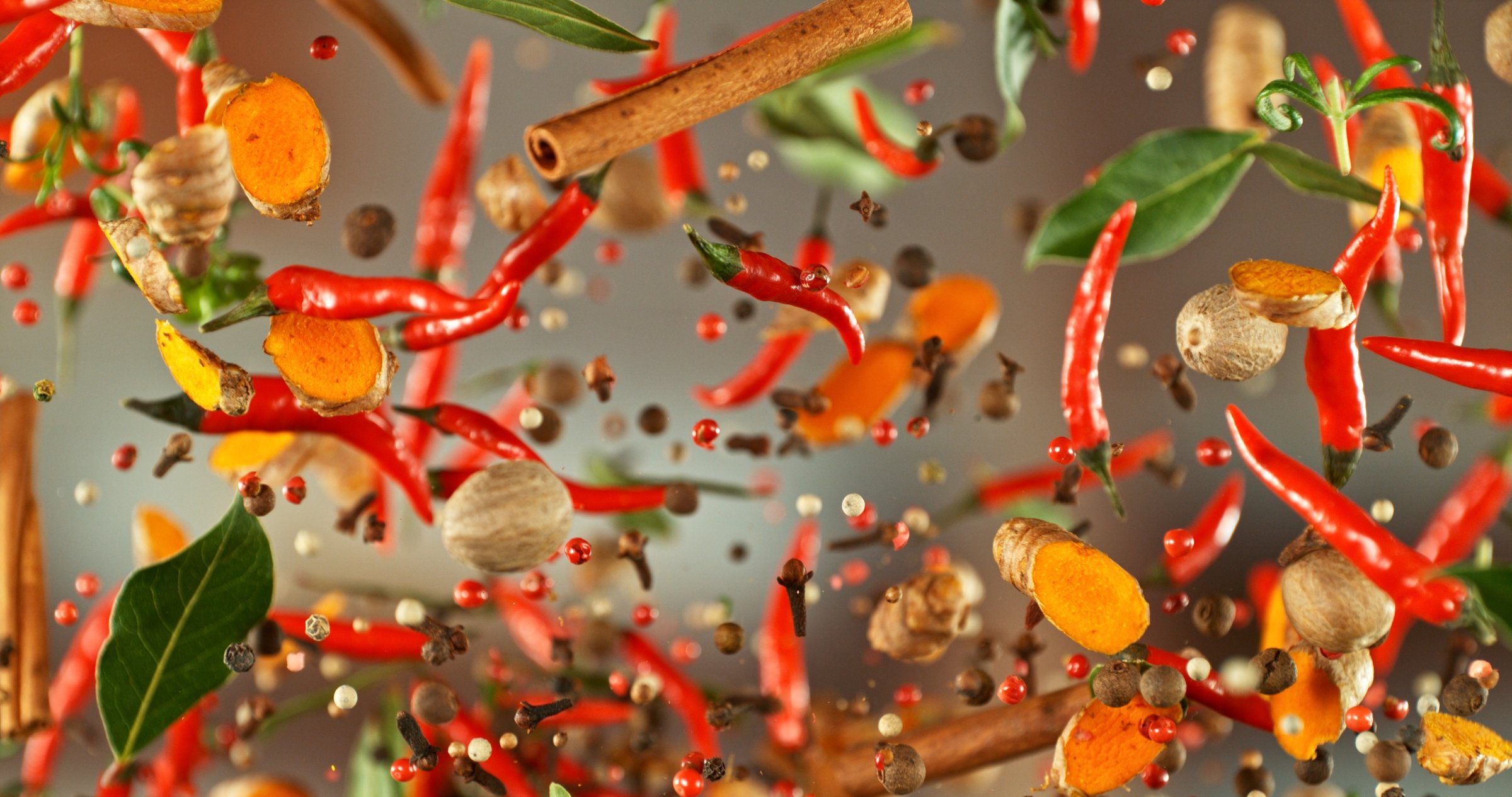 Freeze Motion of Flying Spice. Isolated on Bright Background.