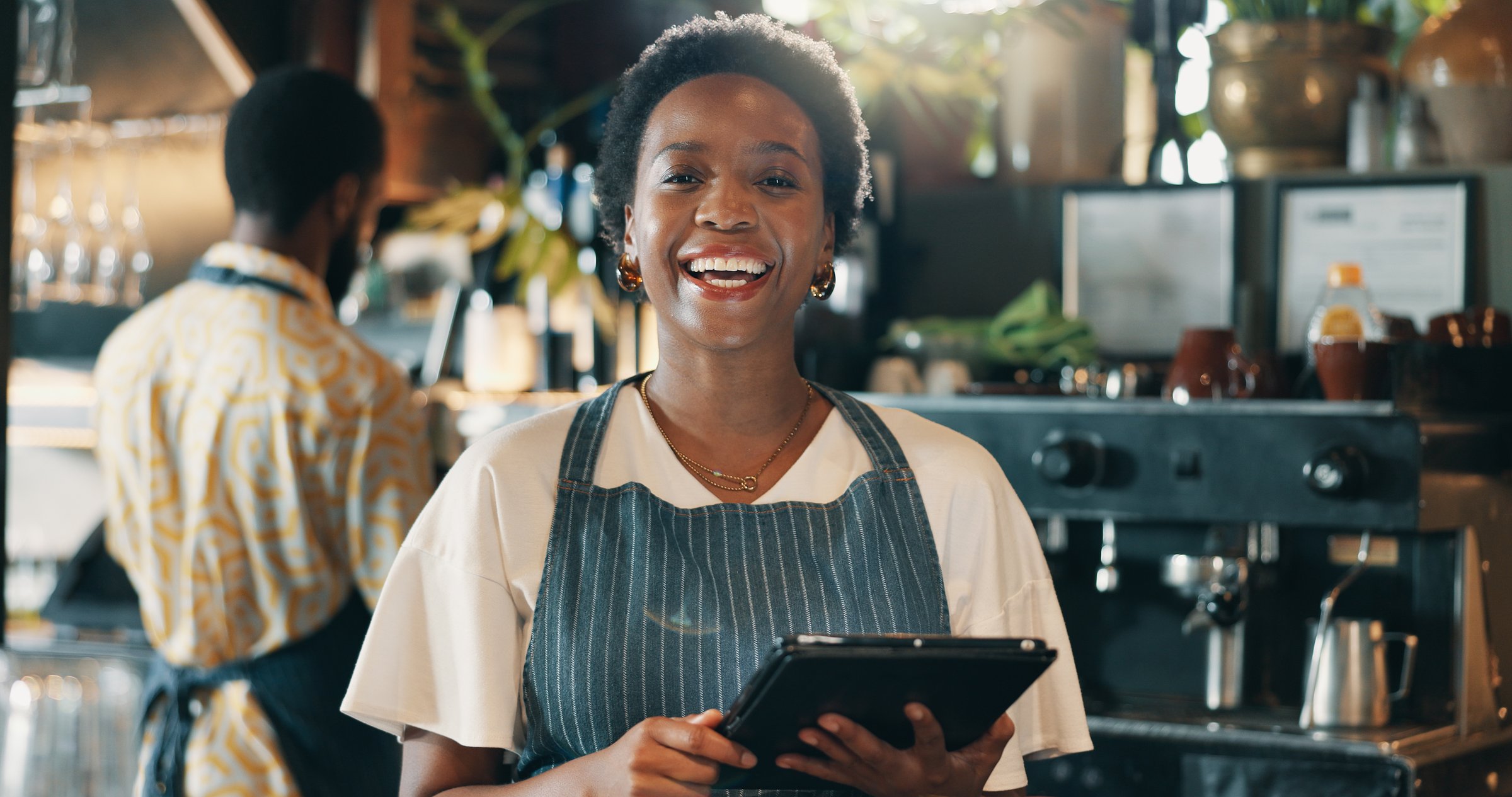 Small business, happy woman and portrait with tablet for cafe, hospitality and tracking stock. Coffee shop, female person and barista with digital for customer service, retail store and online order