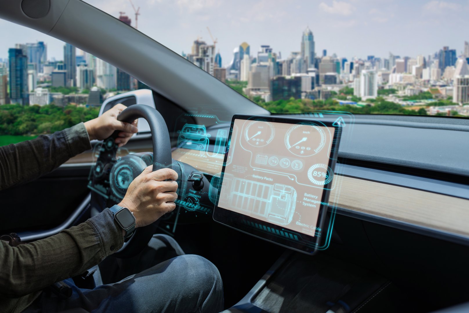 Person driving an electric car with a futuristic, high-tech dashboard and city skyline in the background.