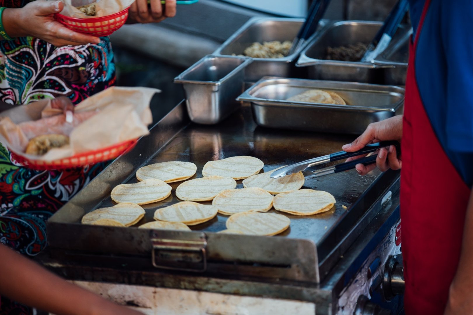 Man serving customers on taco cart in San Diego, California, United States