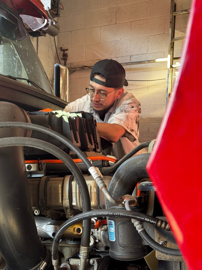 Skilled mechanic focusing on car engine repair with professional tools