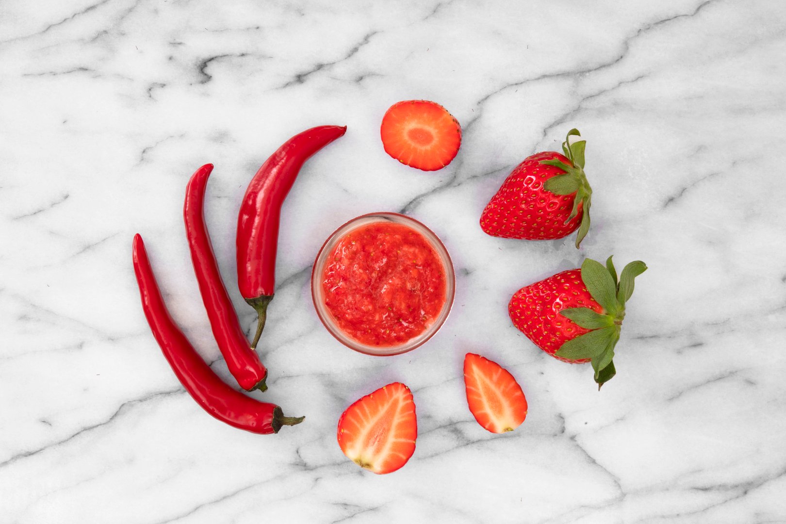 Close-up of strawberries and homemade jam with red peppers