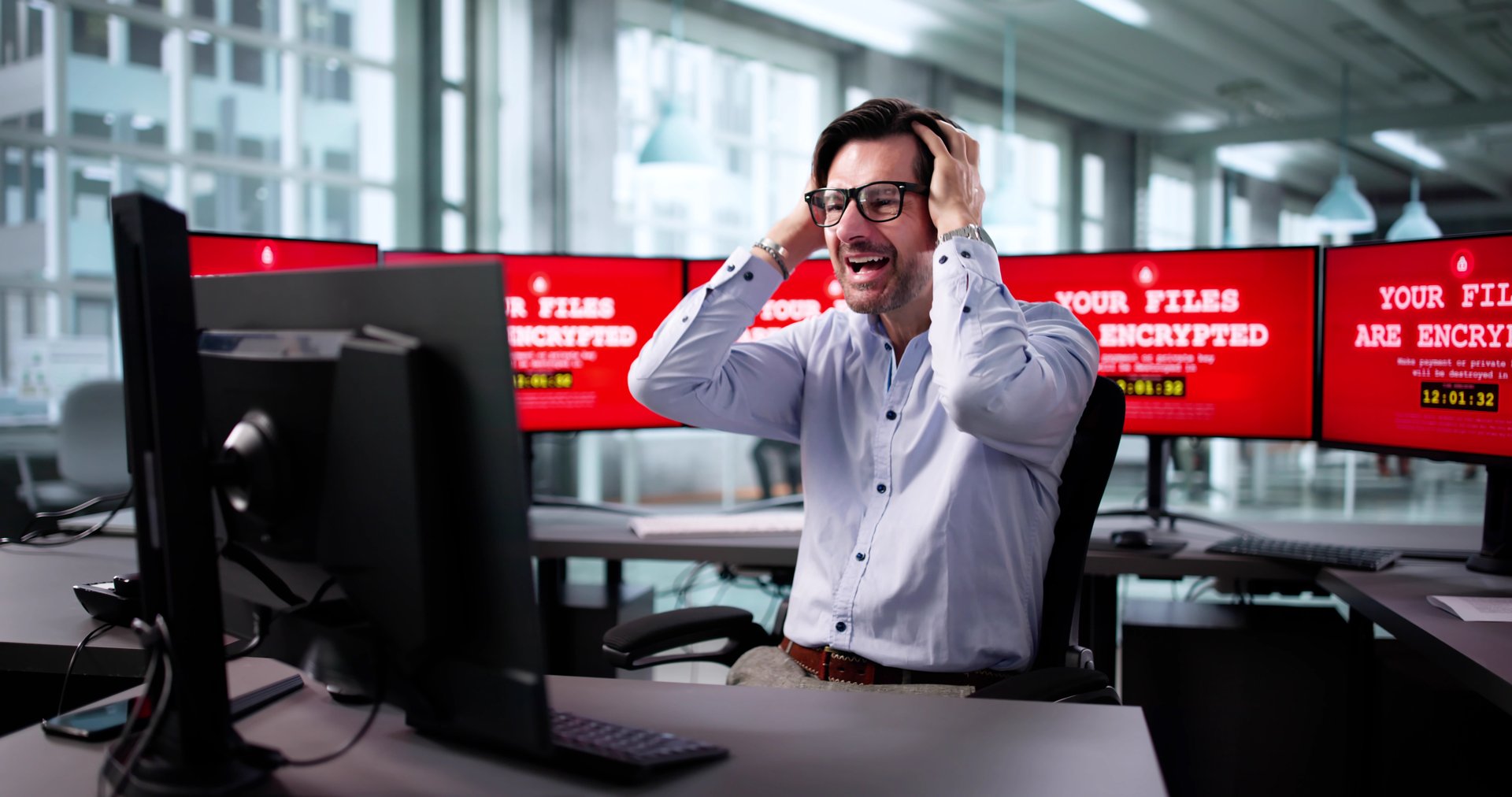 Senior Businessman Worries As Computer Files Are Encrypted In Attack.