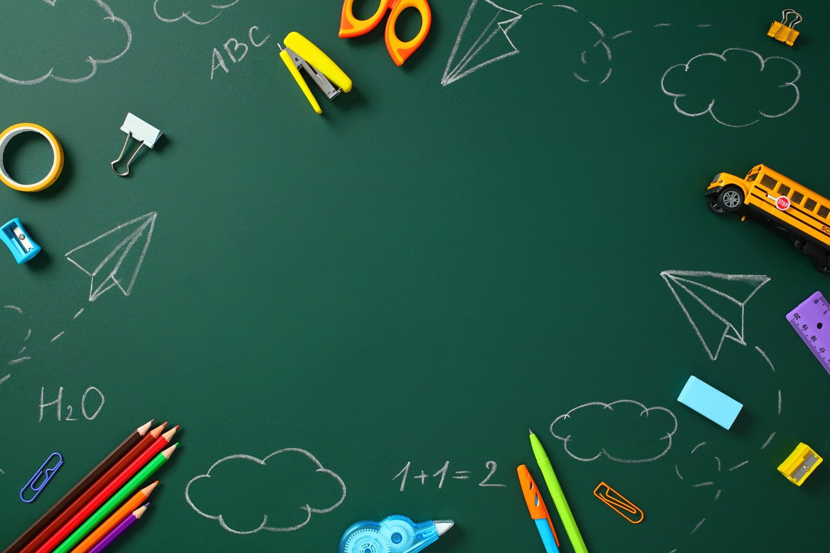 Back to School Concept. Frame of School Supplies on a Green Chalkboard