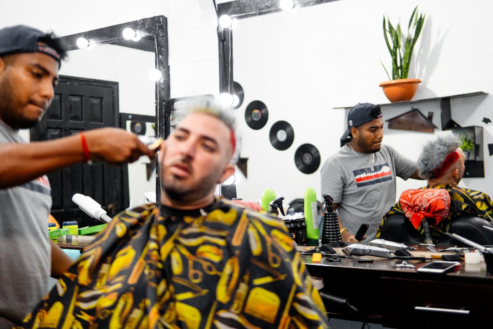 Barbers cutting hair of customers in a barbershop
