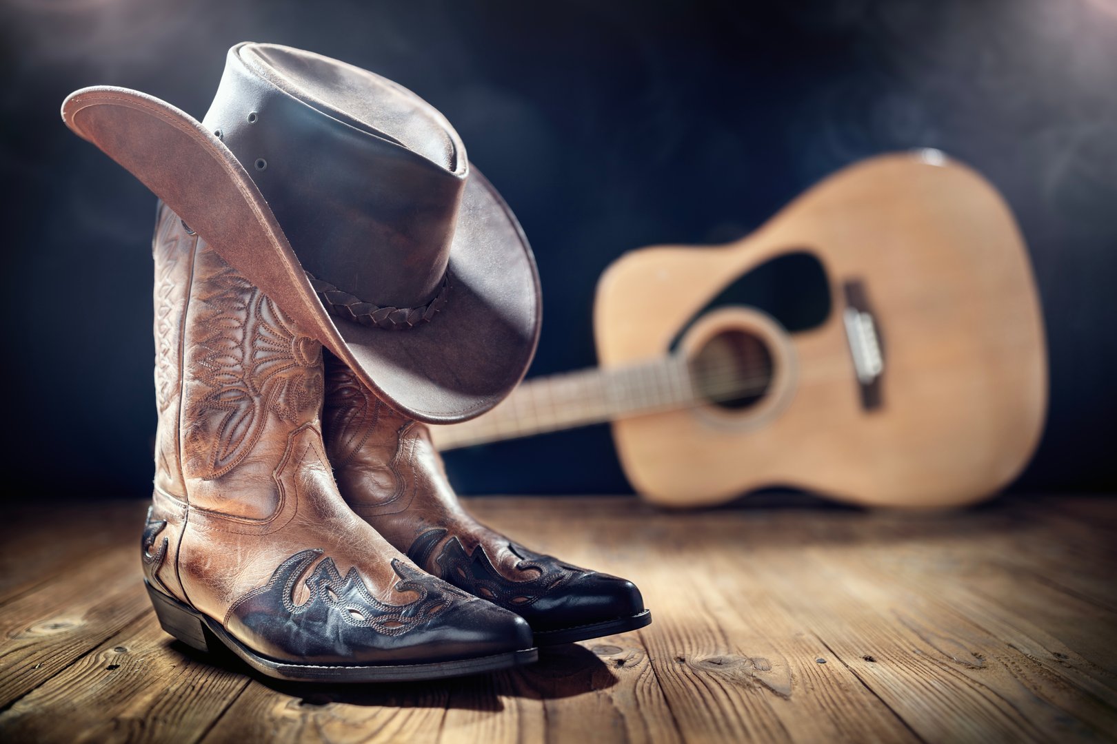 Country music festival live concert with acoustic guitar, cowboy hat and boots background