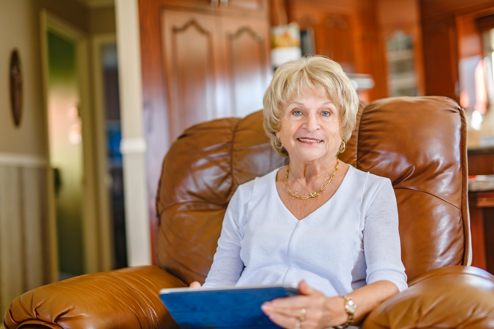 A senior lady posing at home portrait close to a window