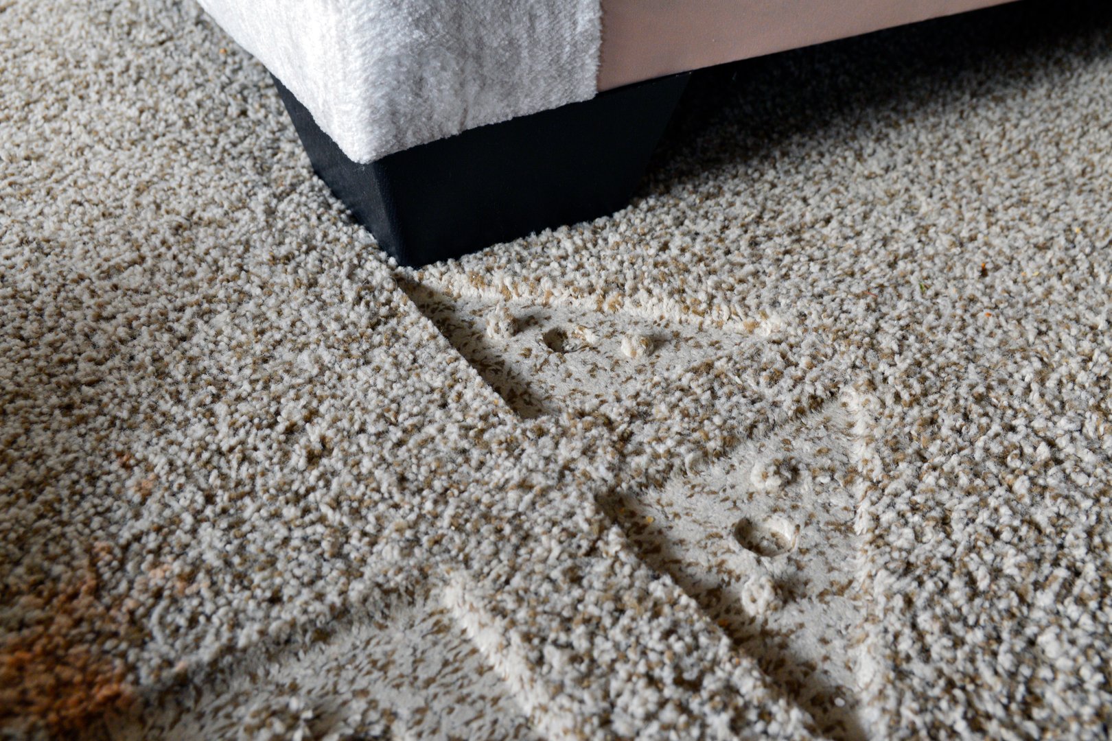 Indentations from furniture in beige carpet in living room