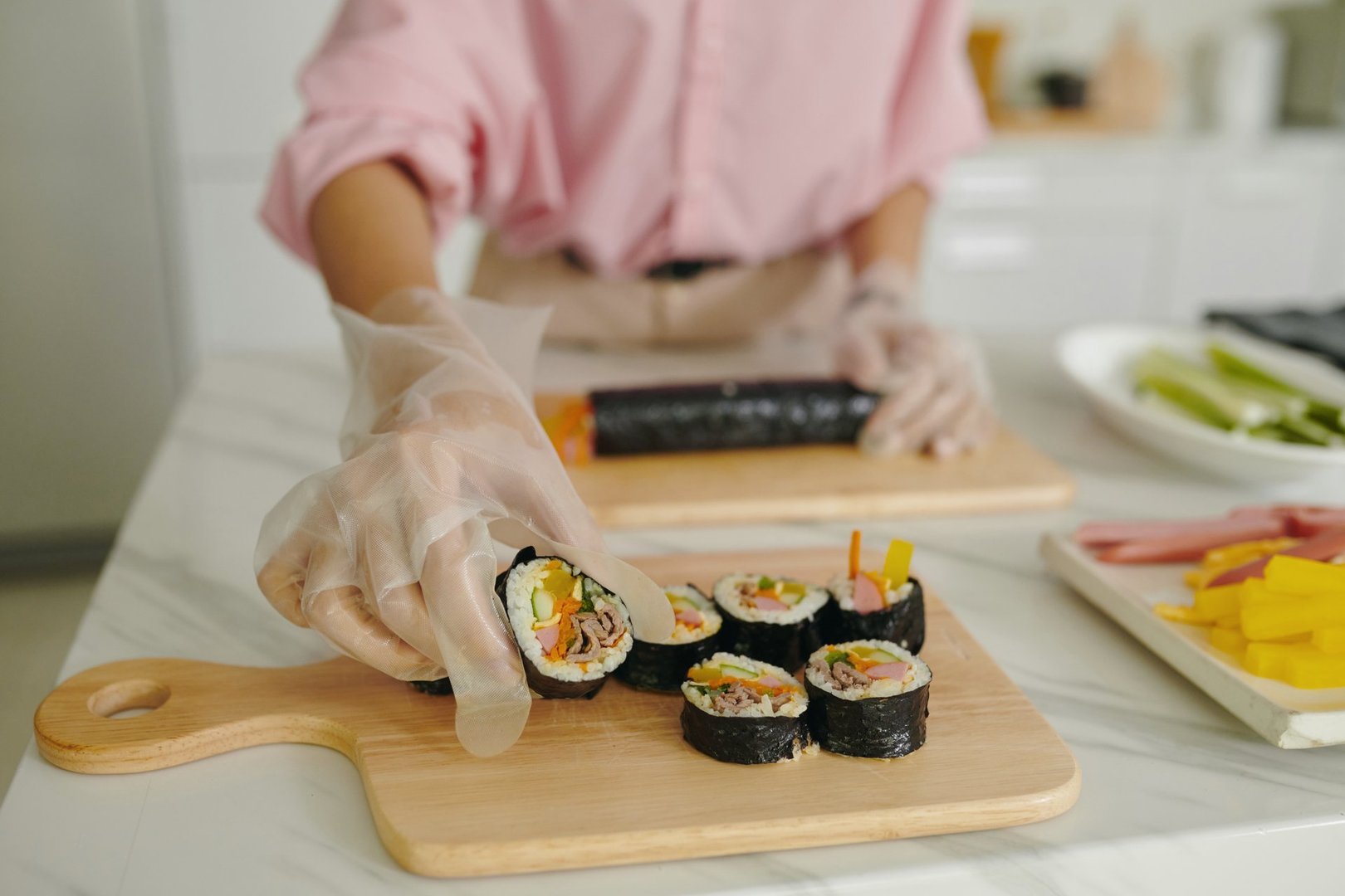 Woman Putting Ready Kimbap On Board