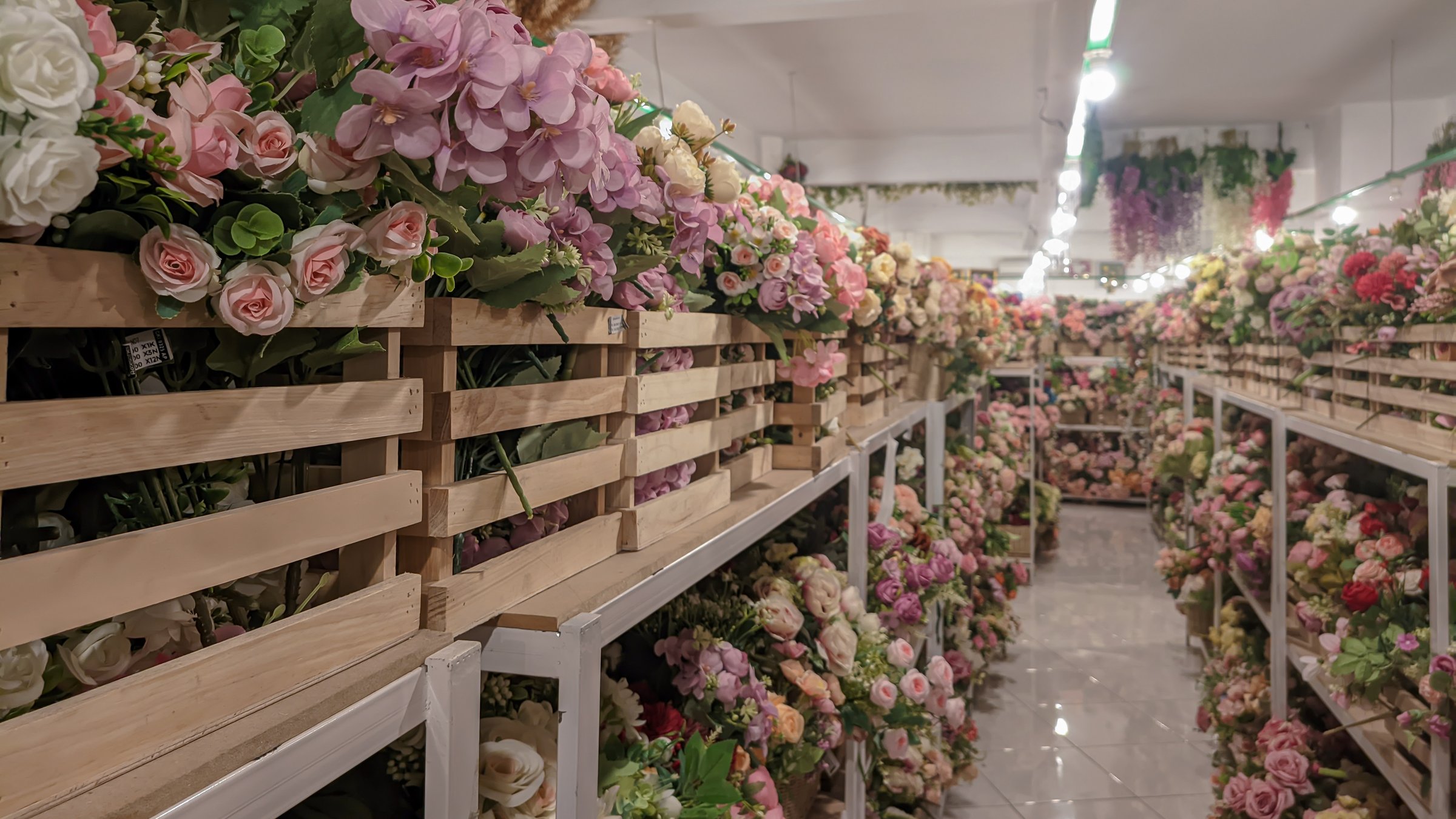 Various types of artificial flowers in various colors for decorative display on store shelves, concepts of variation and diversity.