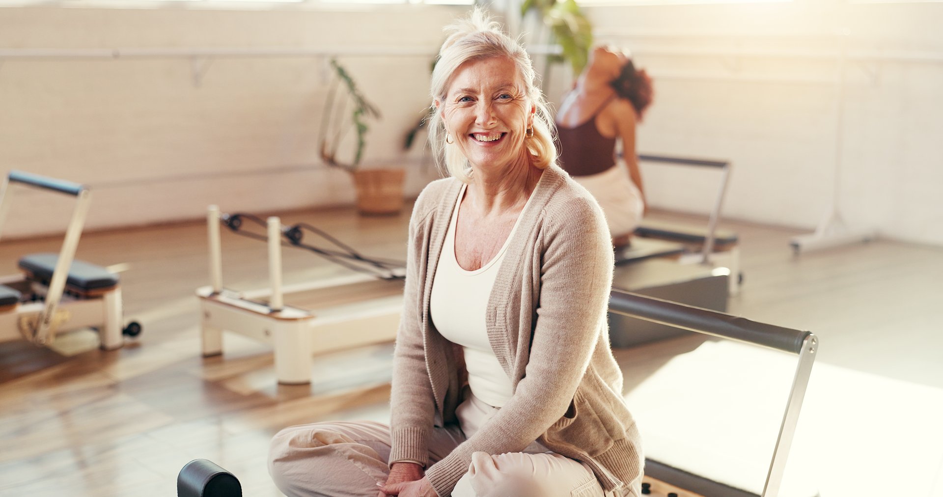 Confident mature woman practicing pilates for healthy aging and menopause wellness