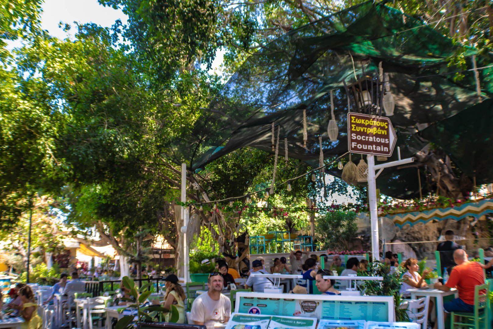 Rhodes, Greece - July 27th 2025: Rhodes old town full of tourists sitting in restaurants in the tree  shade