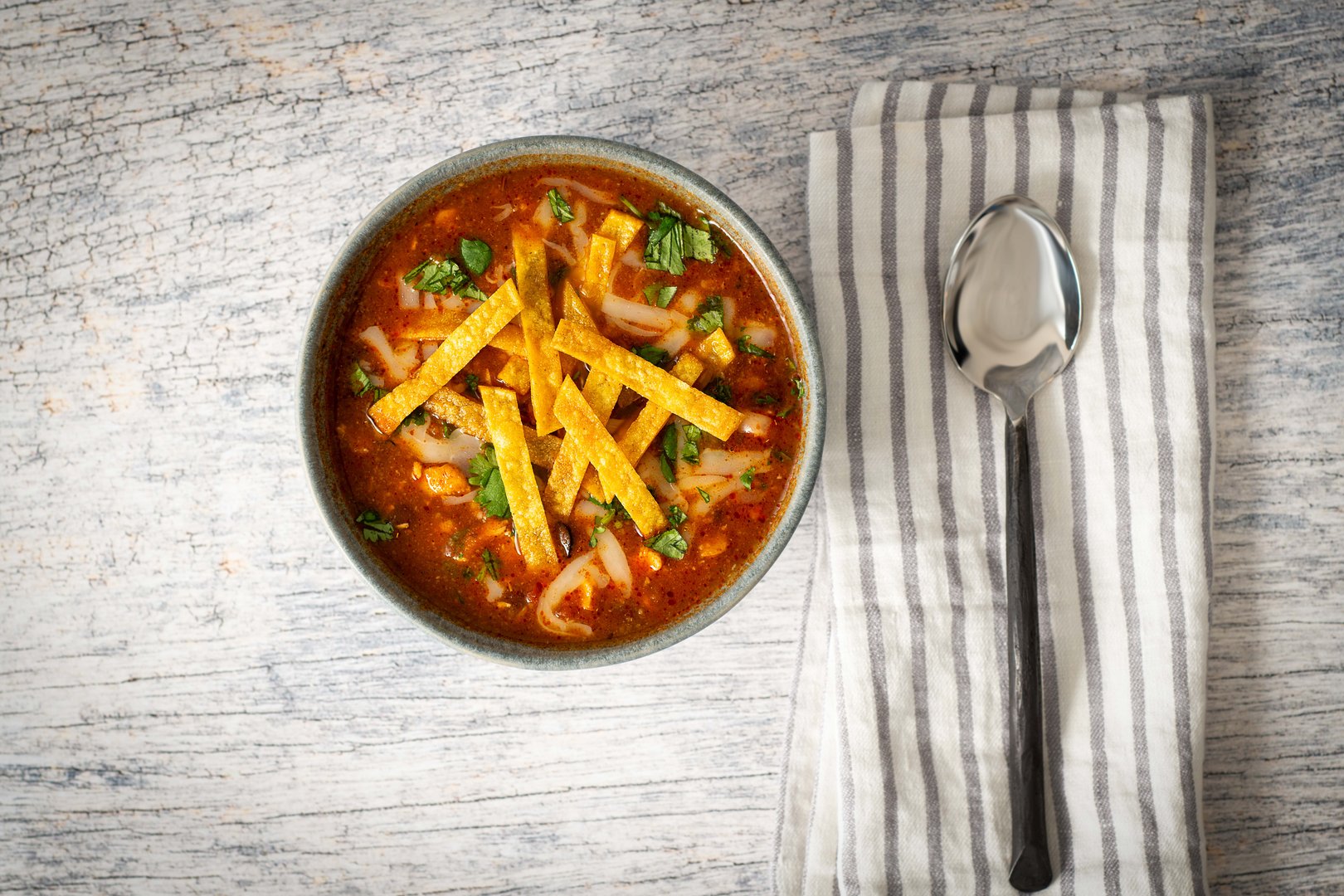 Up-close photo of a bowl of chicken tortilla soup.
