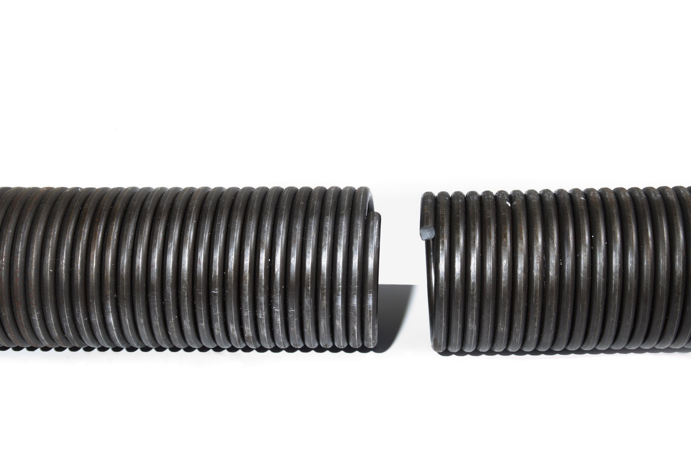 Large sheared-off spring or broken off spring. Repair and maintain large garage gates and doors. Selective focus.