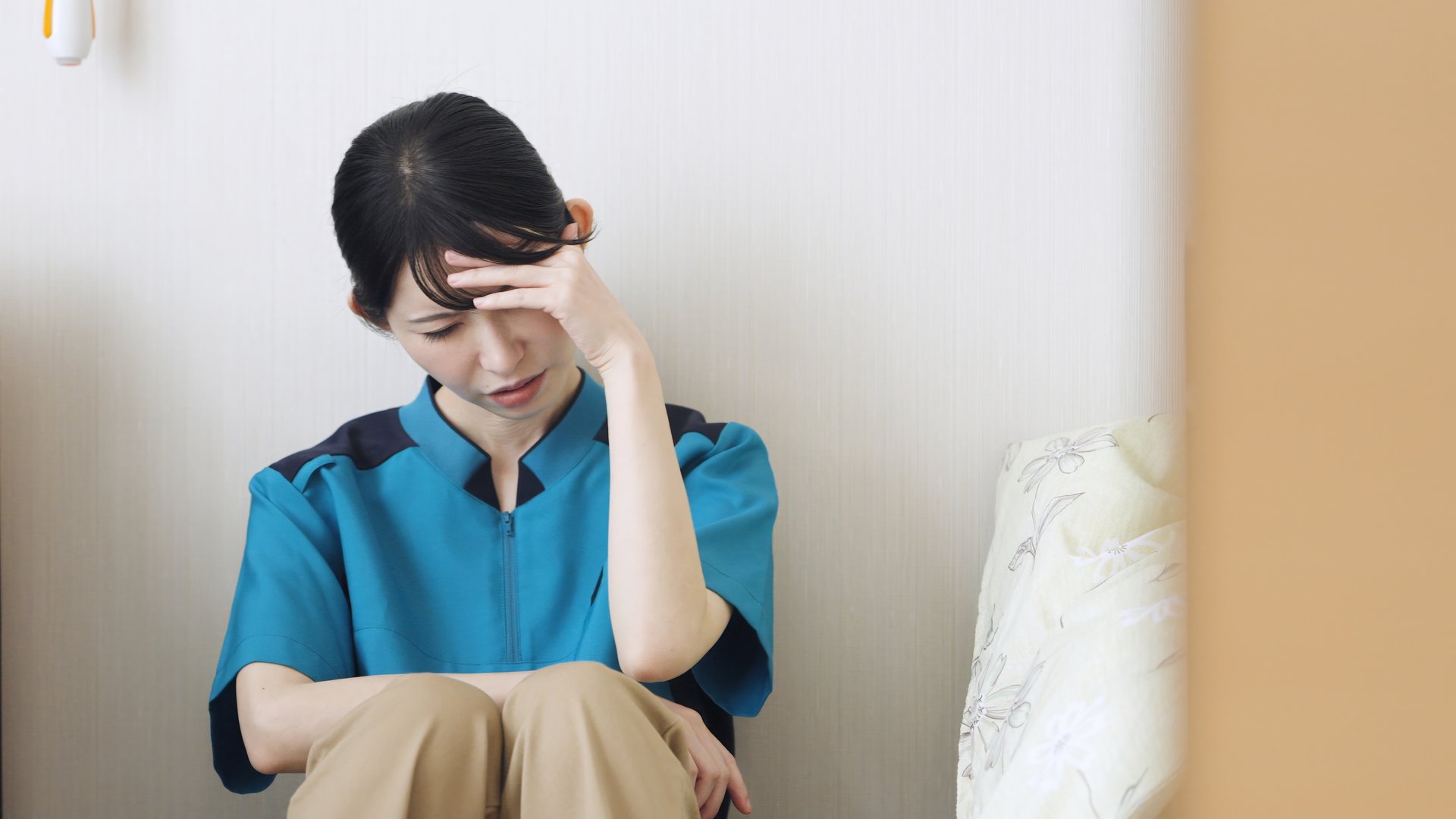 Asian caregiver tired from care work