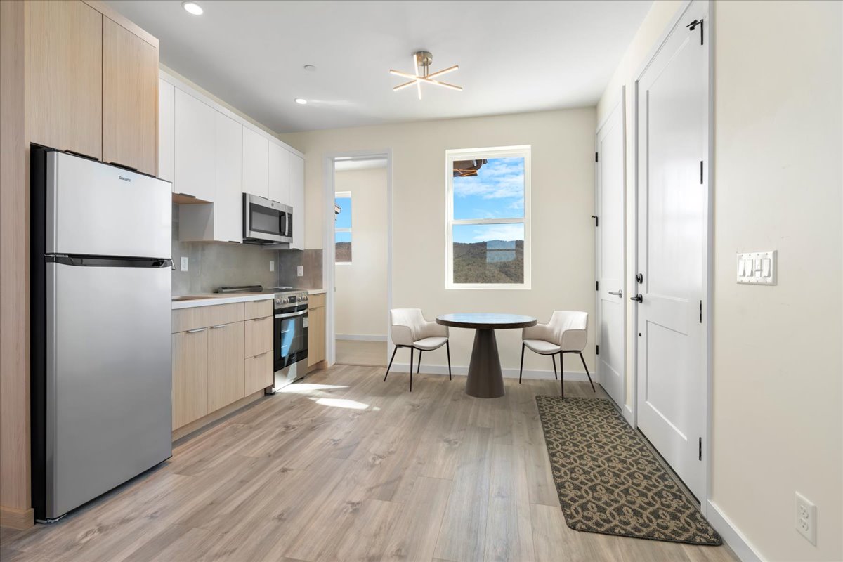 Modern kitchen and dining room with wooden cabinets and island
