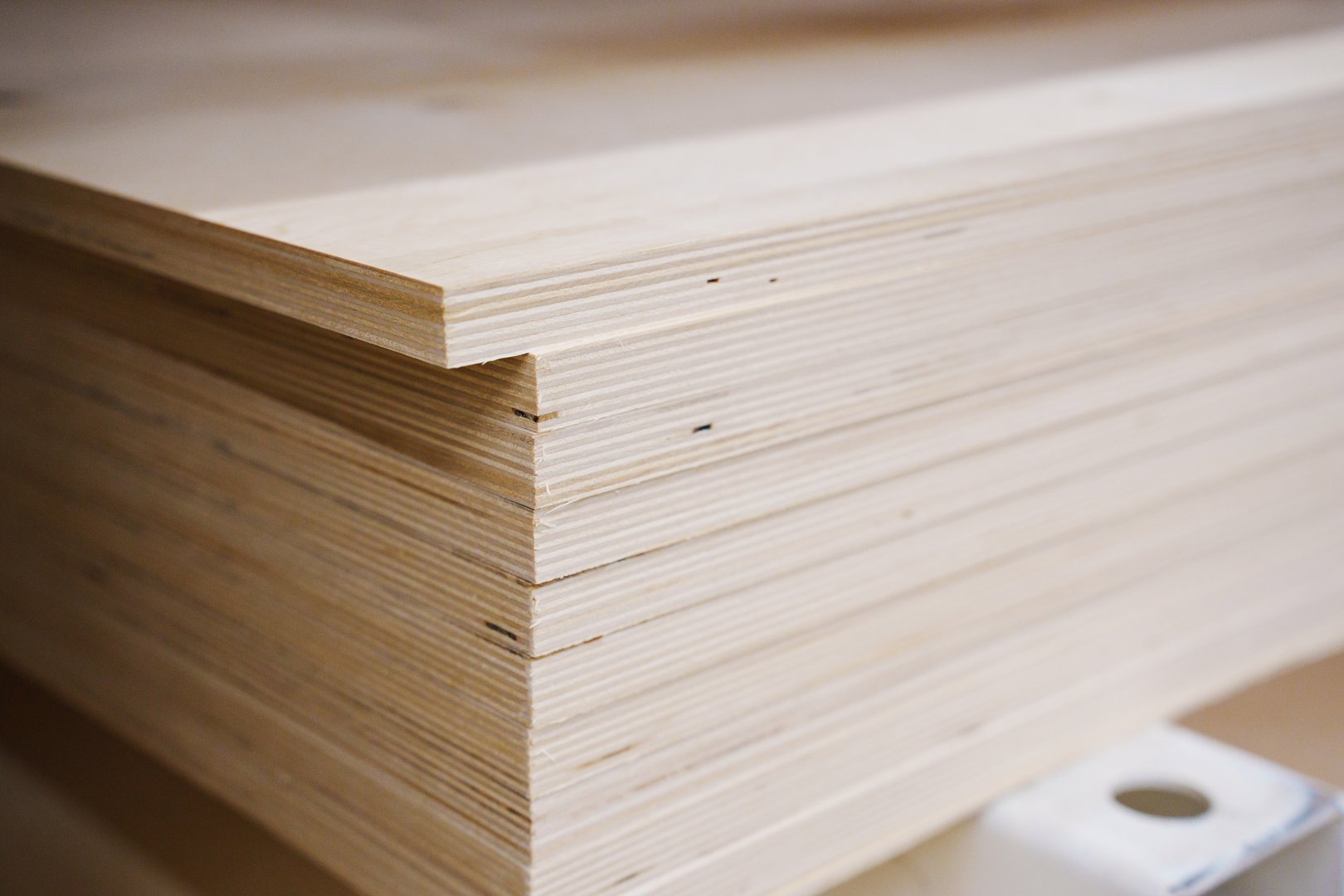 sheets of plywood on a rack in a hardware store. sale of building materials for repair and construction.