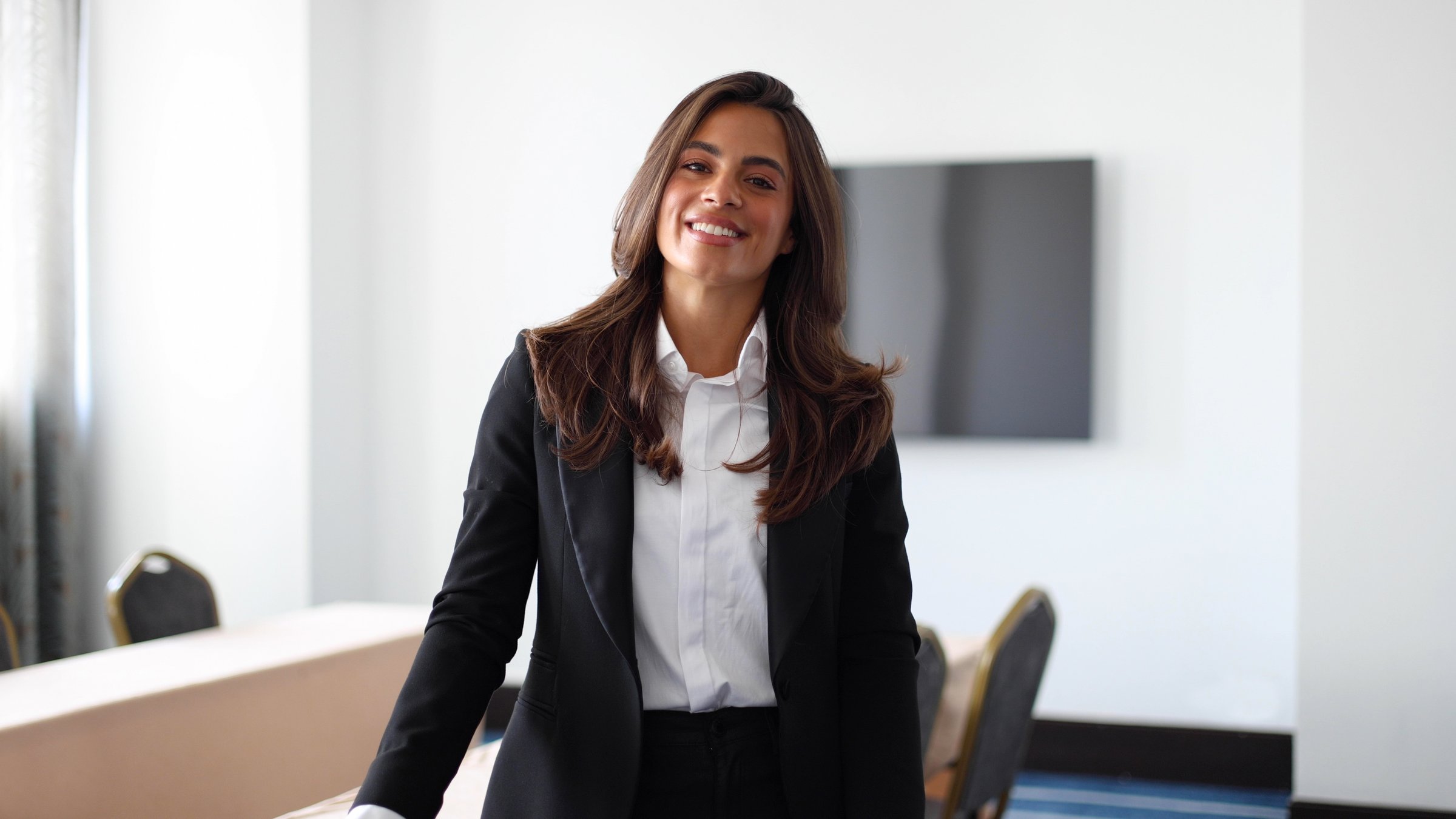 Portrait of a beautiful, young businesswoman posing at the boardroom before a business conference