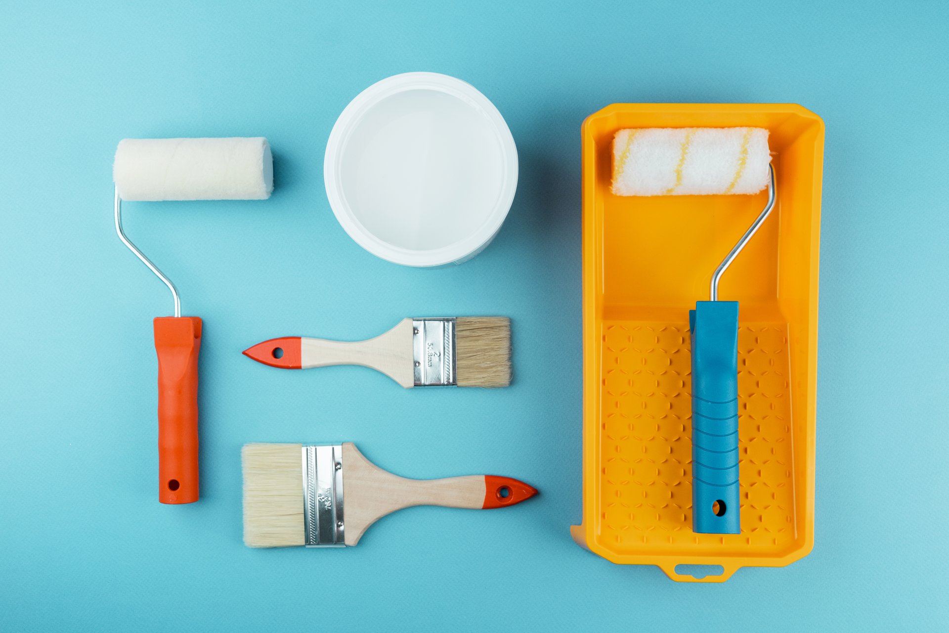 Set of painting tools on cyan background for DIY renovation and household improvement concept