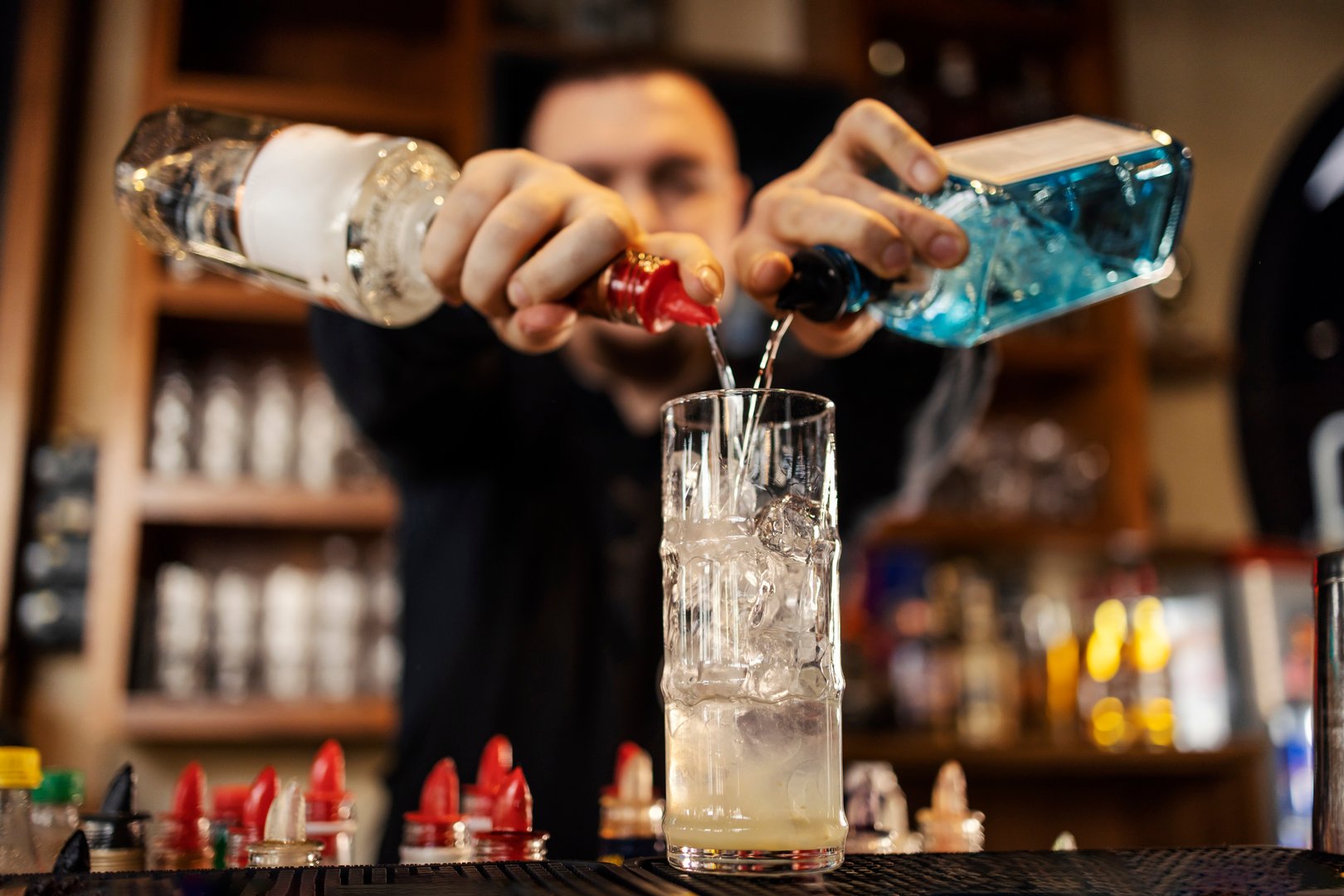 Selective focus on cocktail master making cocktails in a bar.