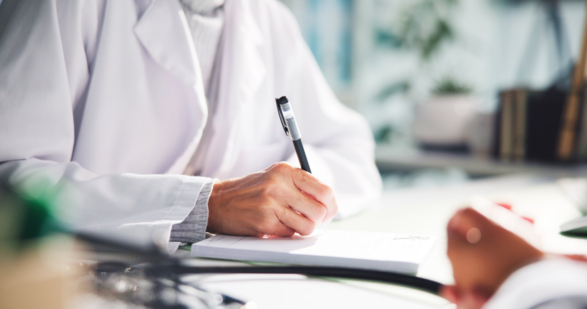 Doctor, hands or writing with patient prescription for diagnosis or sick note at clinic. Nurse, healthcare worker or book with pen or client for medical treatment or pharmaceutical script at hospital