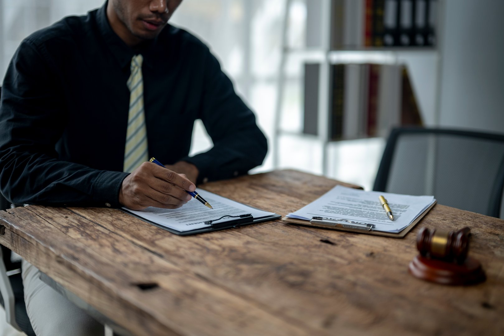 Lawyer reading legal documents and preparing for trial in office