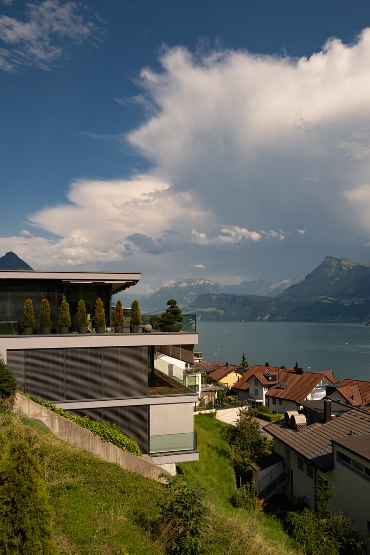 Modern home exterior in nature. Modern home facade in Switzerland. Design ideal for living. Modern style home near Alps mountain. Real Estate of modern home with views of the mountains in the Alps