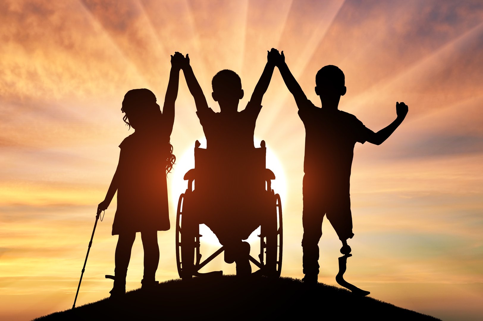 Silhouette Three children with disabilities holding hands in front of a beautiful sunset. Concept strength, unity, and the triumph of the human spirit over adversity