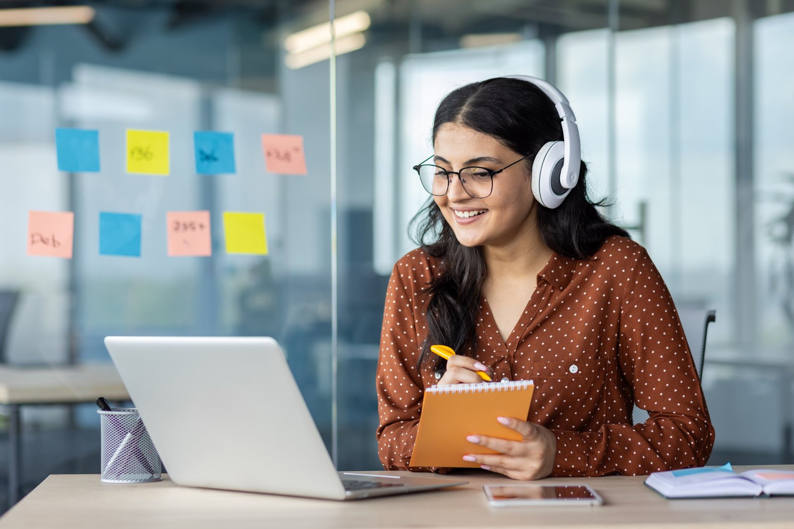 Woman watching online video course, training conference inside office at workplace