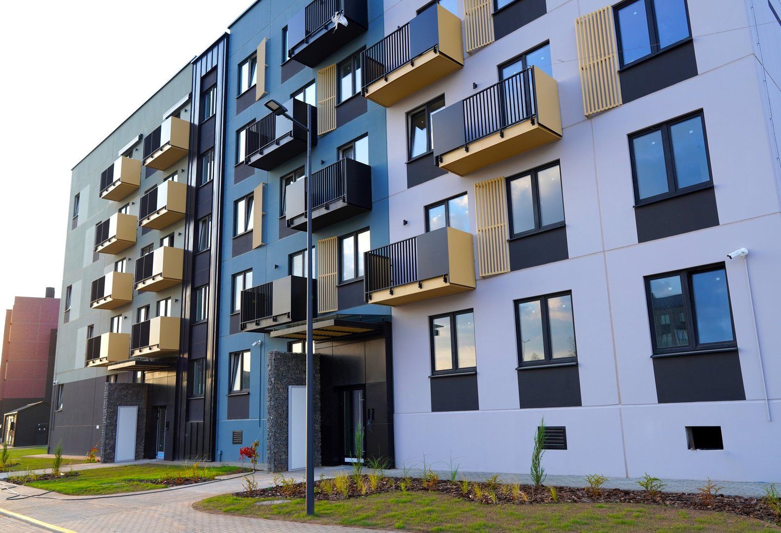 New residential building after construction. Renovation of multi-storey building. Multi-colored facade of residential building. Completed construction of house. Housing Renovation. Facade