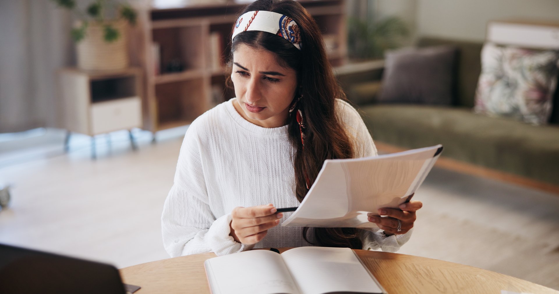 Finance, stress and woman in home with documents for financial planning, savings and investment. Anxiety, worry and person with paperwork, bills and taxes for mortgage, debt payment and expenses