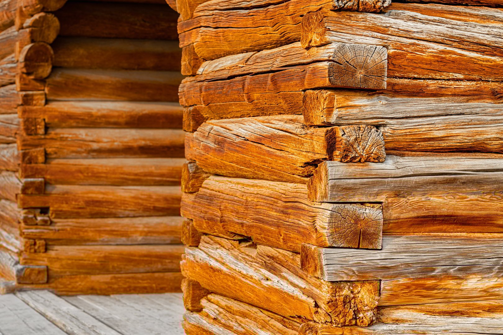 a fragment of a wooden frame made from old logs. log house made of natural logs. log house. ancient technology of house construction