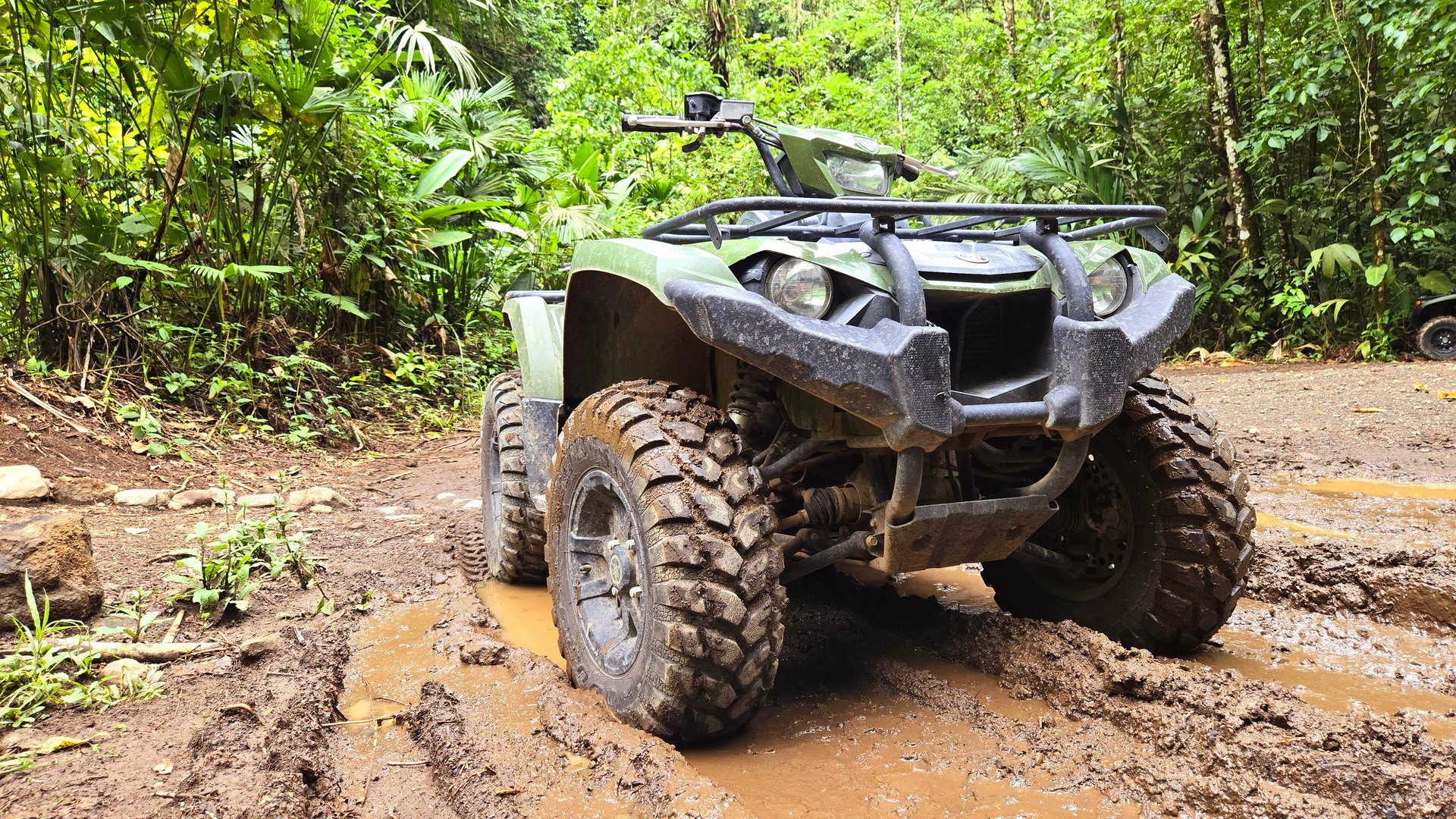 Four wheeler in the mud in a rainforest in Costa Rica in the rain