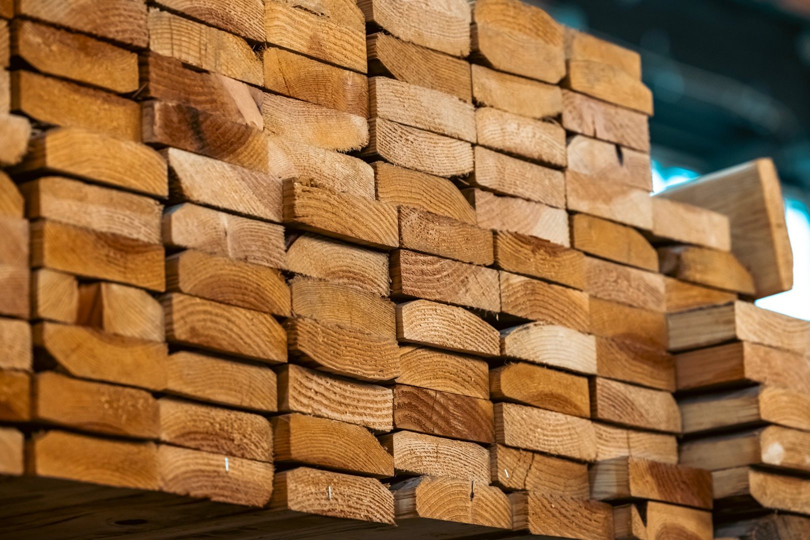 A Machinery Warehouse with Stacked Wood Organized and Ready for Commercial Construction Use
