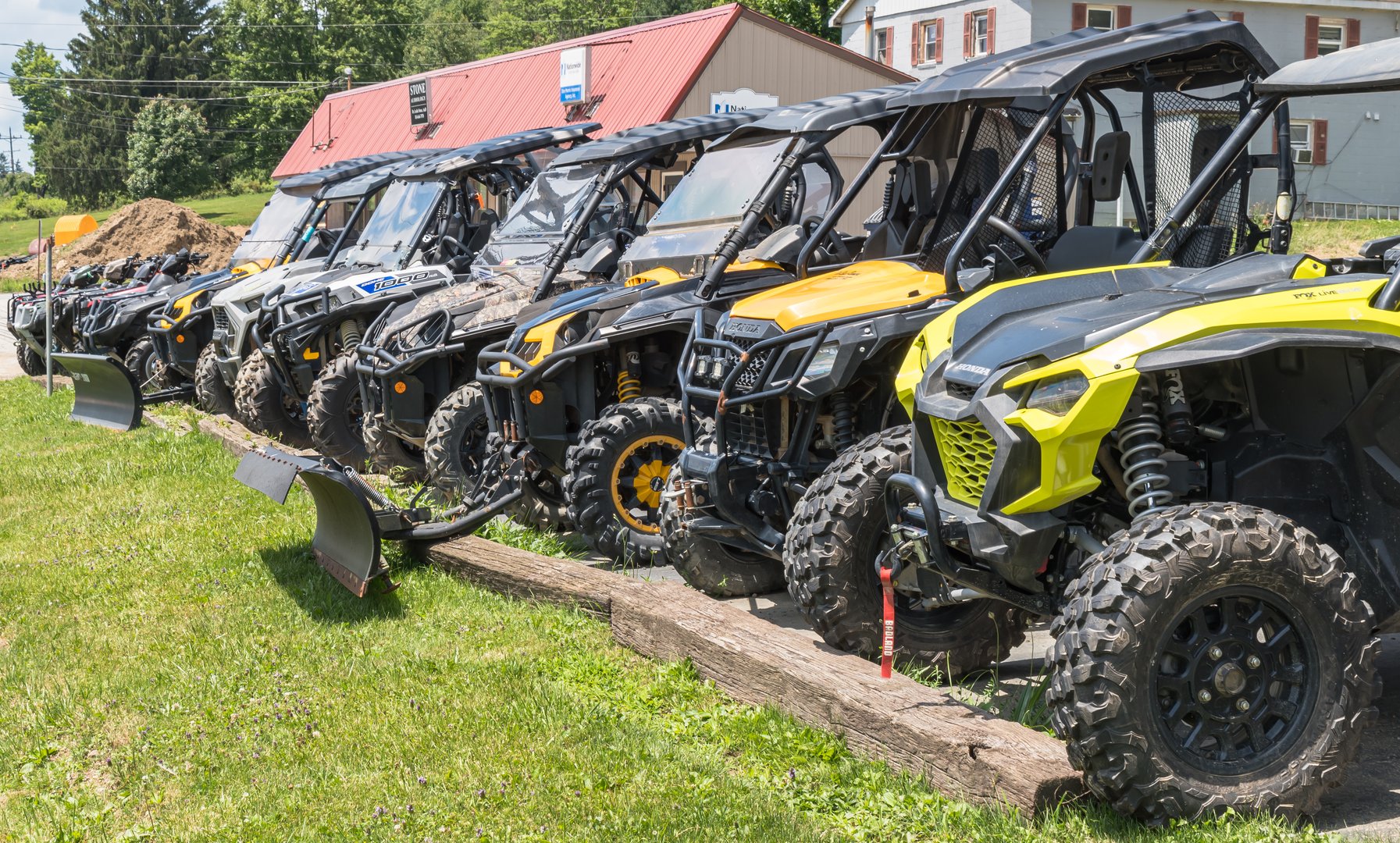 Corry, Pennsylvania, USA July 7, 2024 A line of different UTV models at a dealership on a sunny summer day