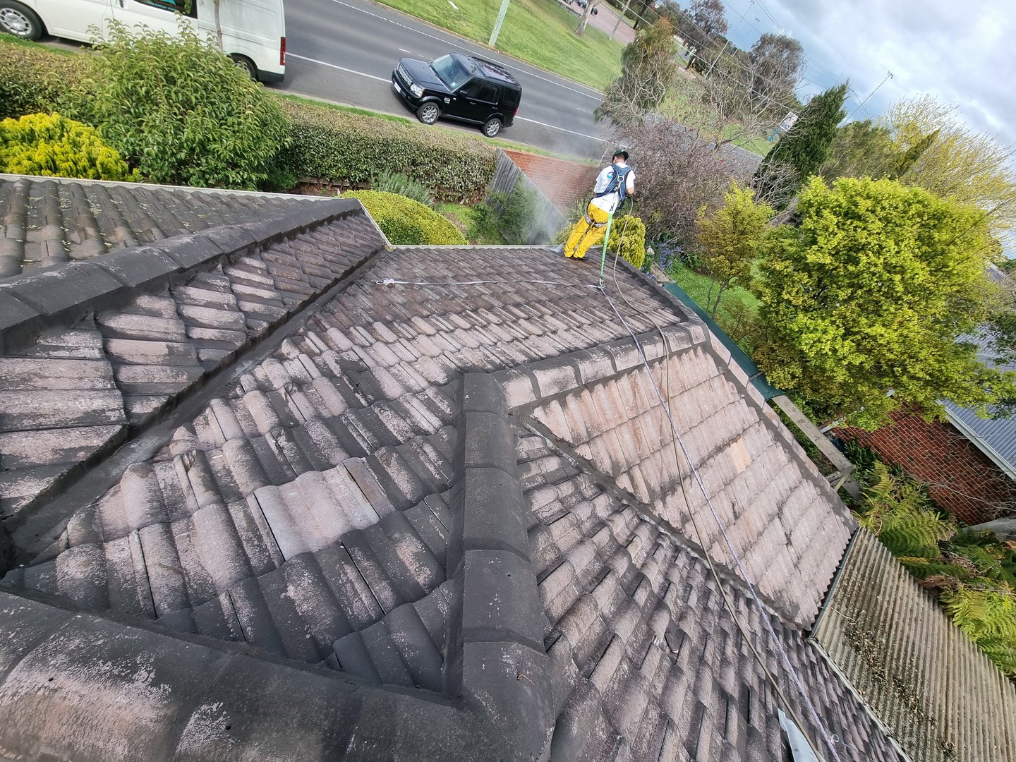 Quality Painting Group tile roof before restoration showing weathered and damaged condition
