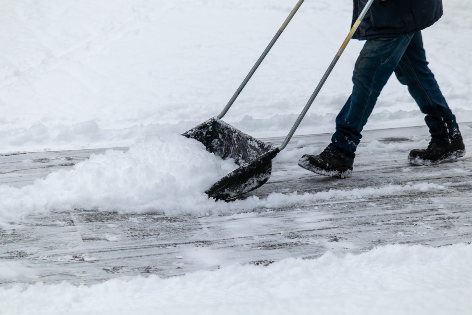 Man is shoveling snow with a snow shovel