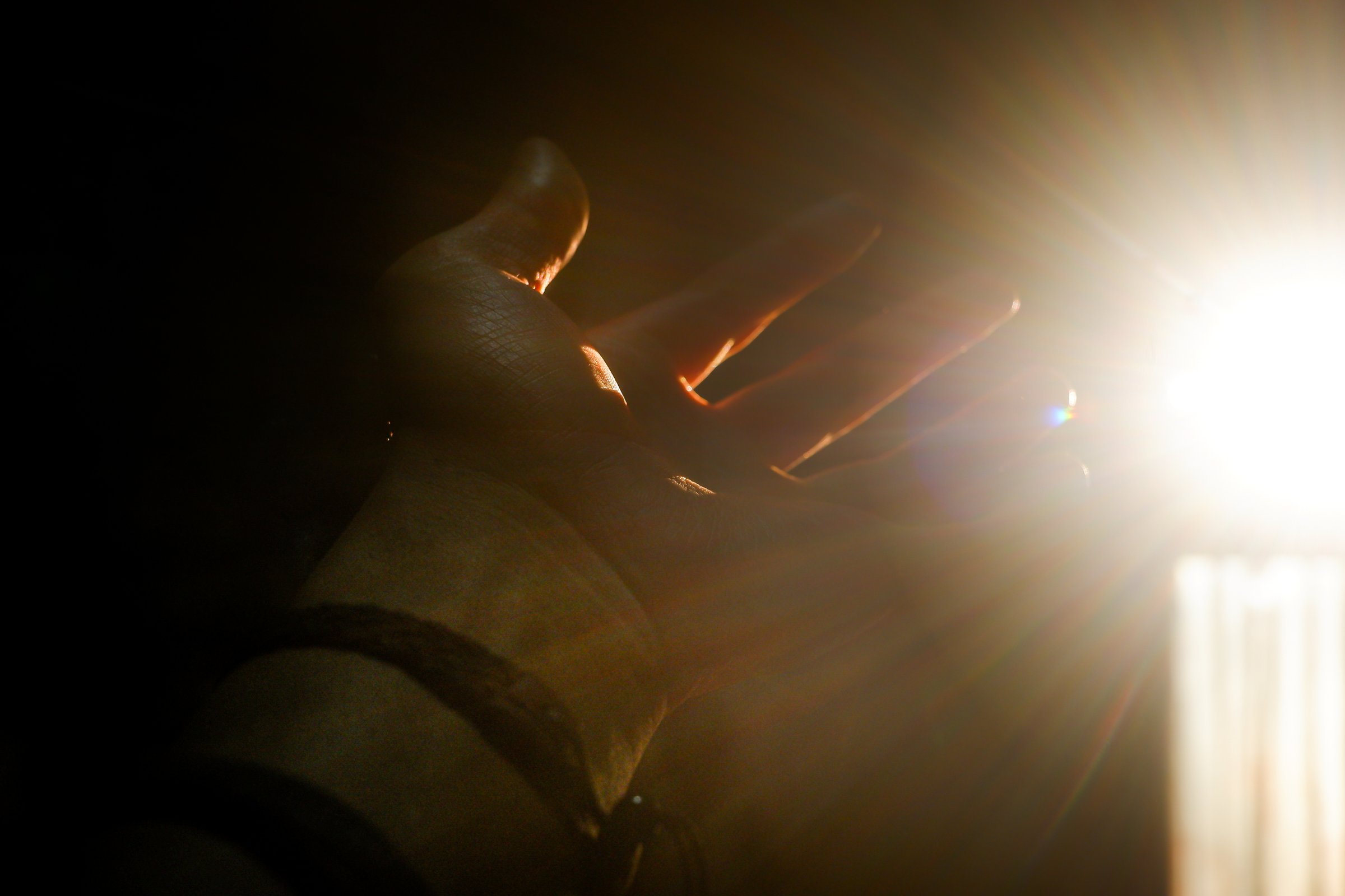 Hand Reaching for Light – Symbolic Hope and Faith Concept