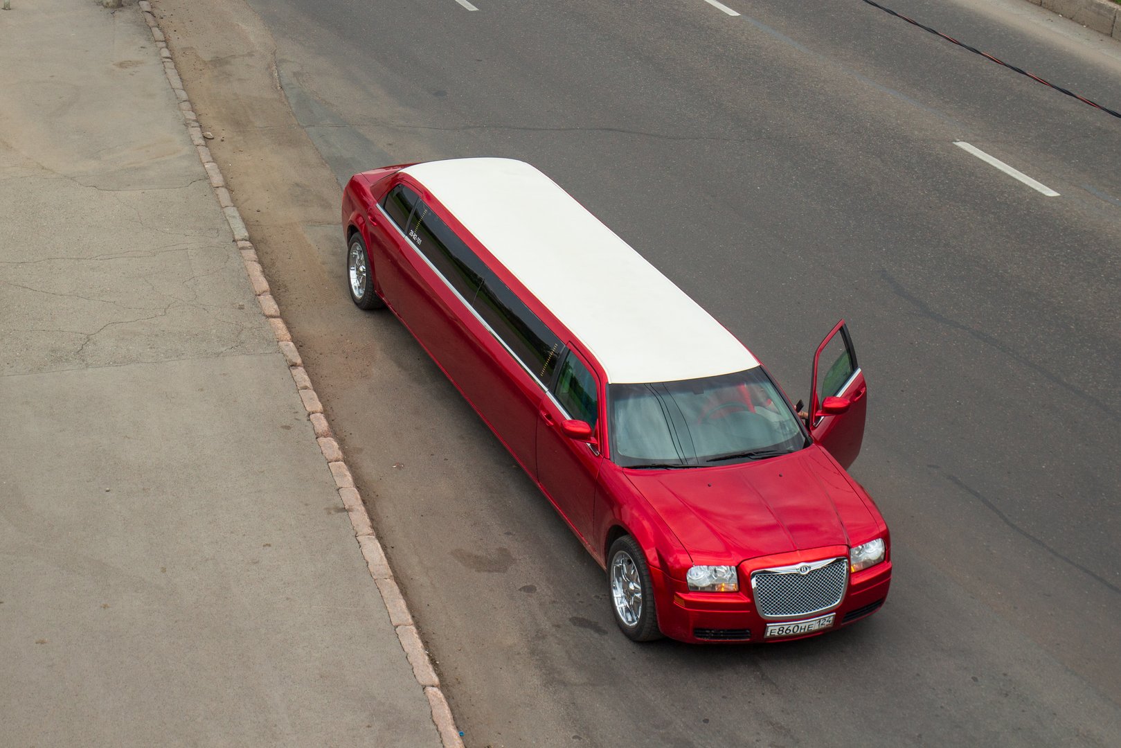 Krasnoyarsk, Russia - June 28, 2021: Red Chrysler 300c limousine with open door