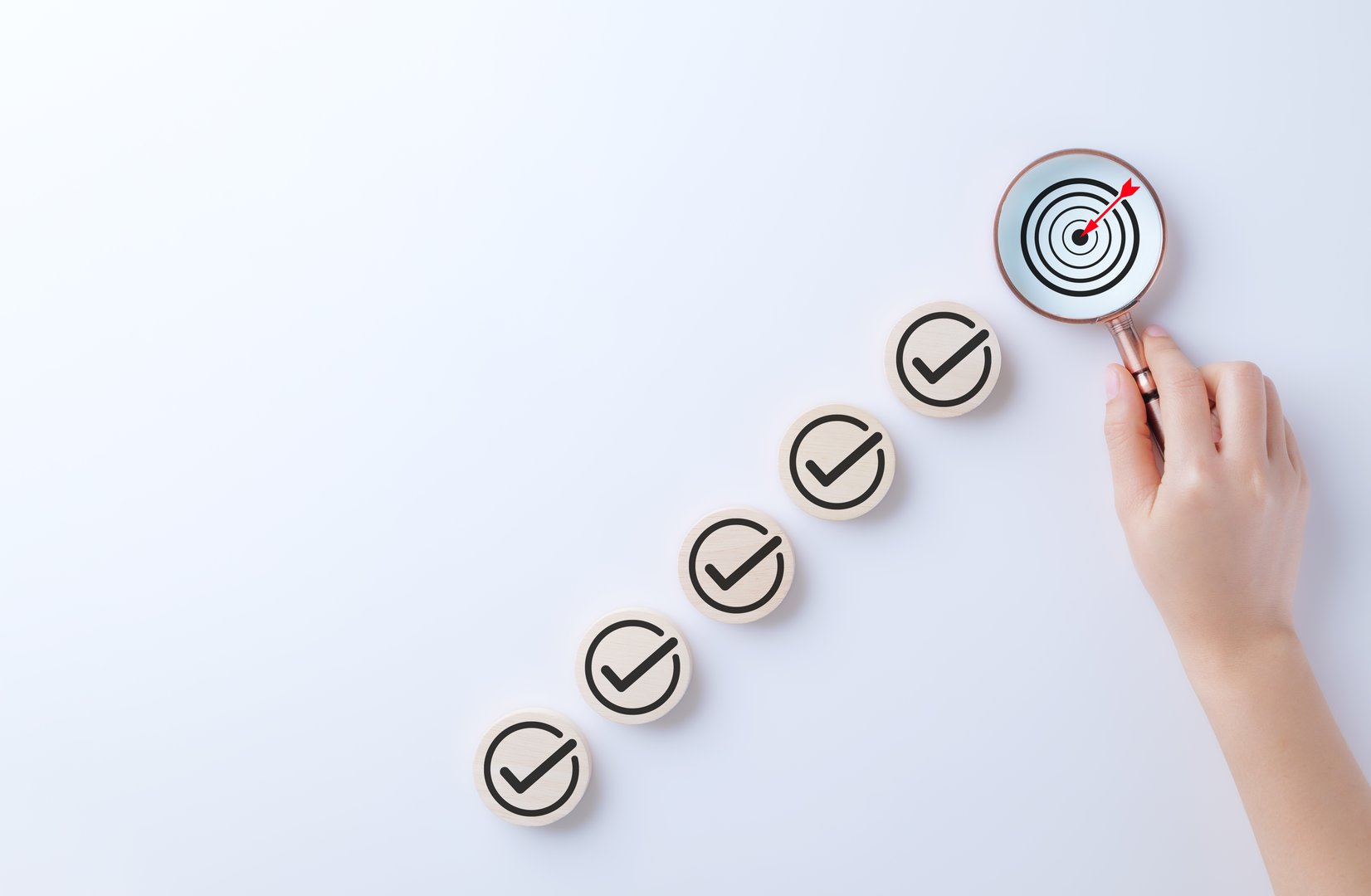 Business strategy planning and quality management concept. Magnifying glass focuses on target icon and arrow with check marks. business goal setting, strategy planning, quality management processes,