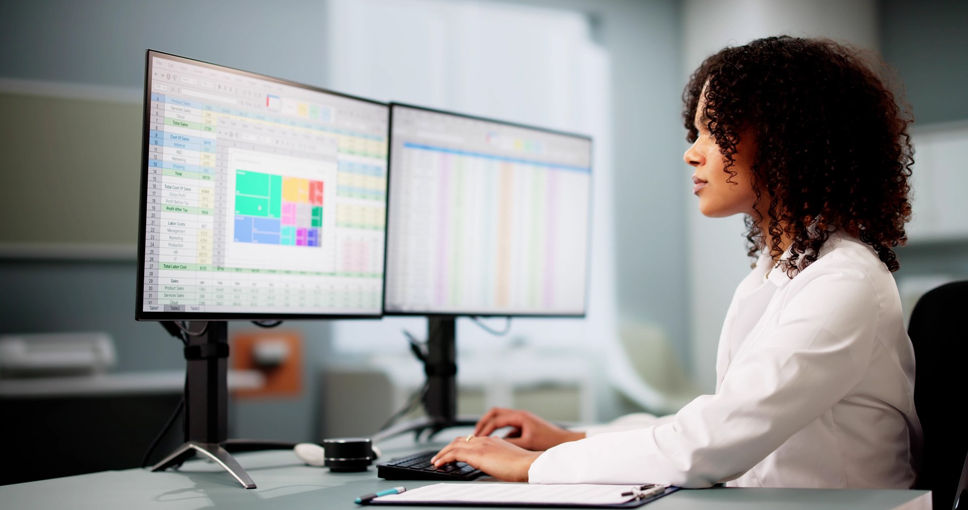 Hospital Doctor Using Spreadsheet For Billing Codes On Desktop