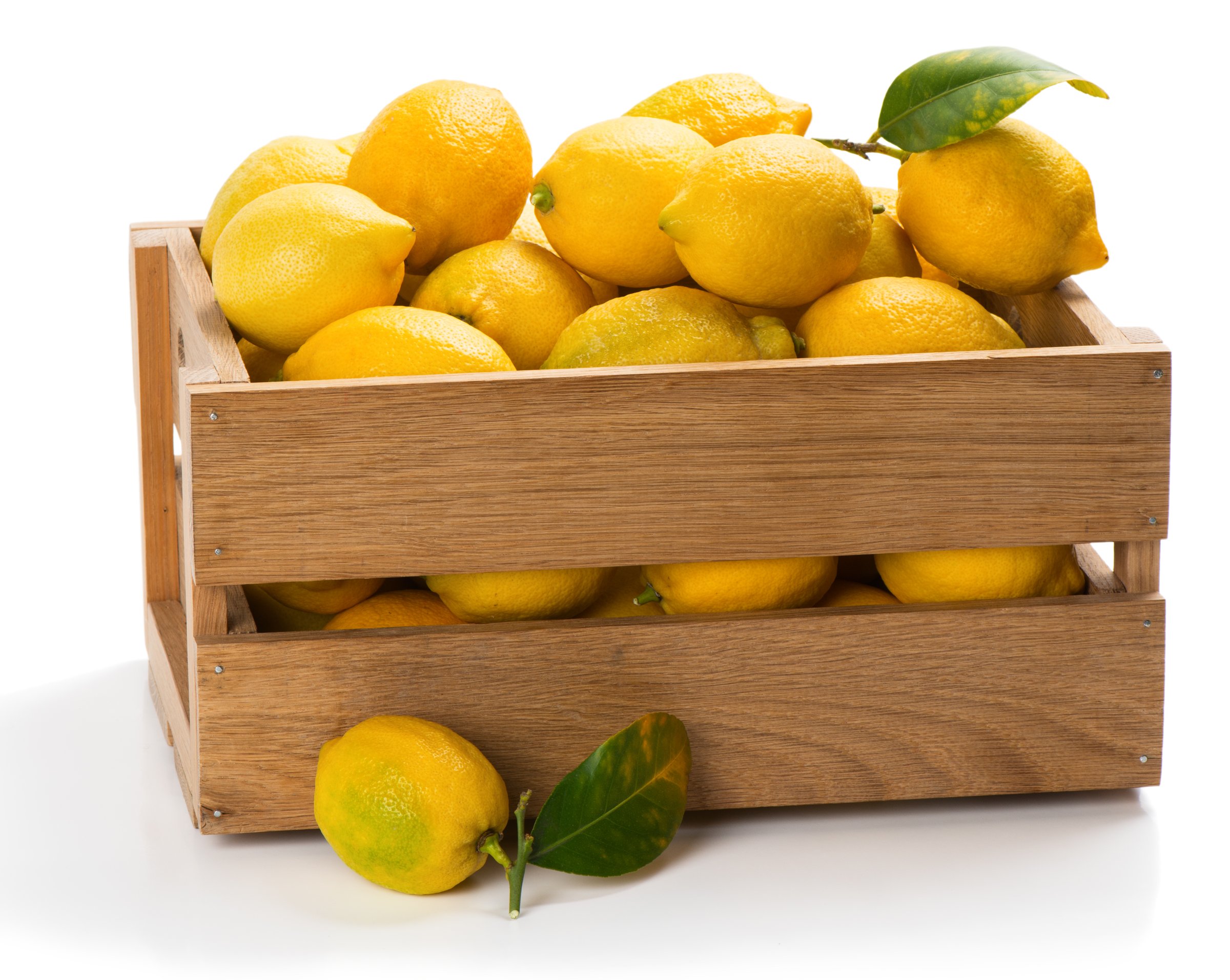 Wooden crate filled with fresh lemons