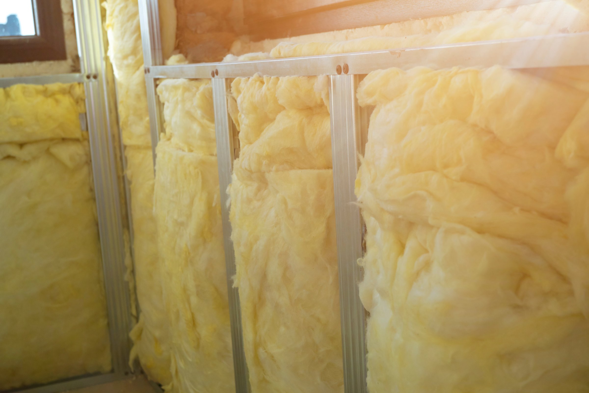 The yellow mineral insulation provides thermal and acoustic insulation.