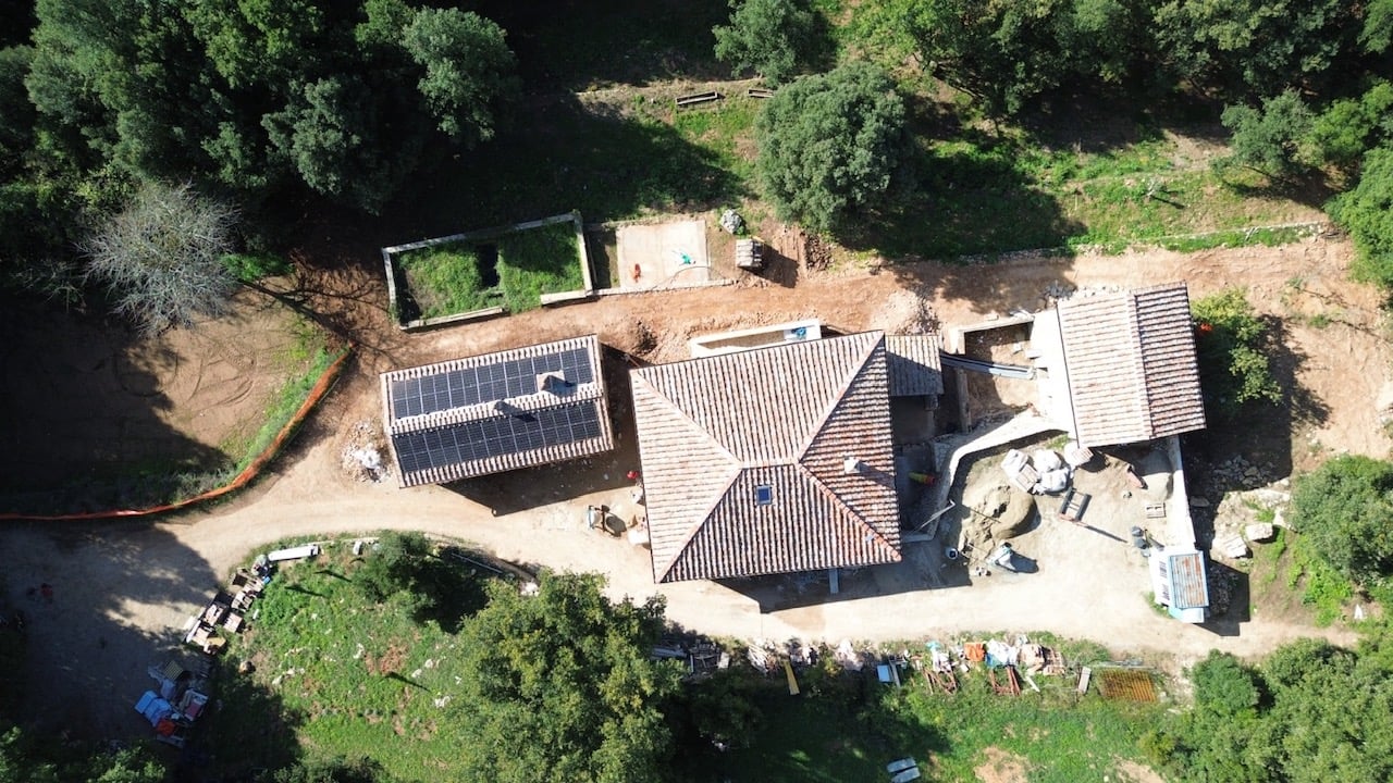 Wine bottles and glasses on a table in Italy