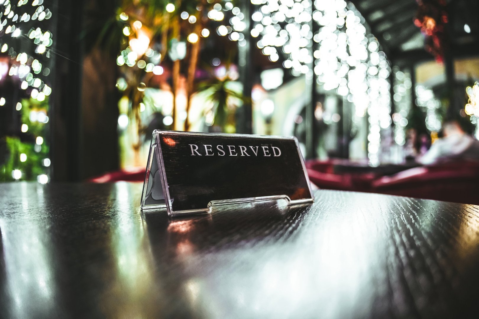 Close up of a reserved sign, located on a table of a restaurant.