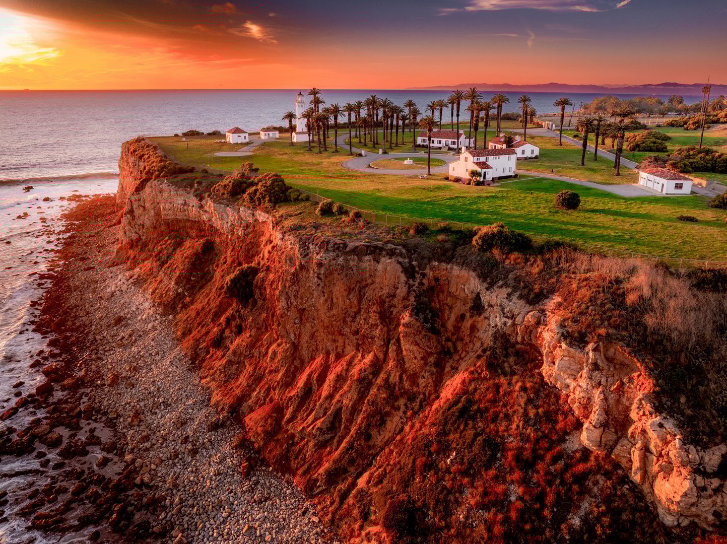 Aerial view of coastline of Rancho Palos Verdes with landmark lighthouse during dramatic skies on a colorful Springtime day
